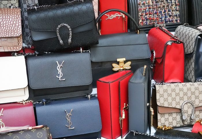 Bunch of fake brand bags at the bazaar. Istanbul, Turkey, September 22., 2018: Bunch of fake brand bags at the bazaar