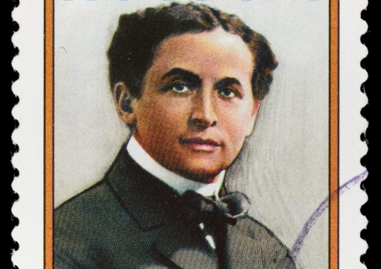 Sacramento, California, USA - March 21, 2012: A 2002 USA postage stamp with a portrait of master magician Harry Houdini (1874-1926). Houdini's magic acts, especially his feats of escape, helped his name become synonymous with the word 'magician' to many Americans of that era.