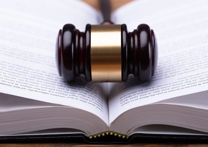 Close-up Of Gavel And Law Book Close-up Of Wooden Gavel And Open Law Book
