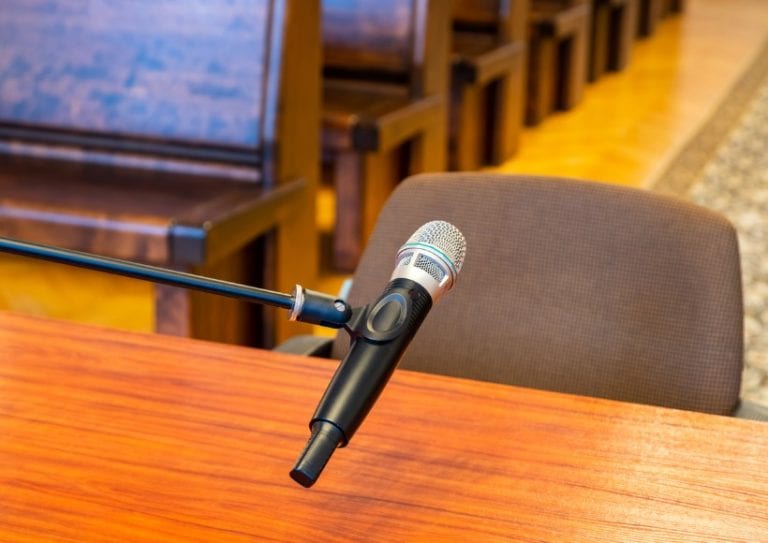 closeup-of-microphone-in-the-courthouse-justice-system-witness-picture-id1299975522