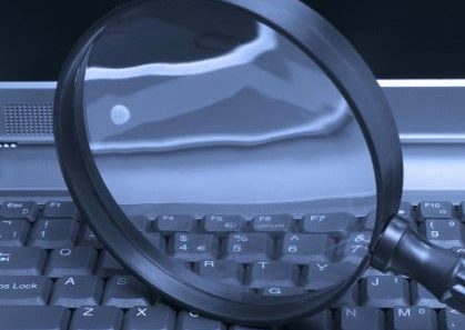Laptop with a magnifying glass, concept of online security and investigation. Laptop with a magnifying glass, concept of online security and investigation.