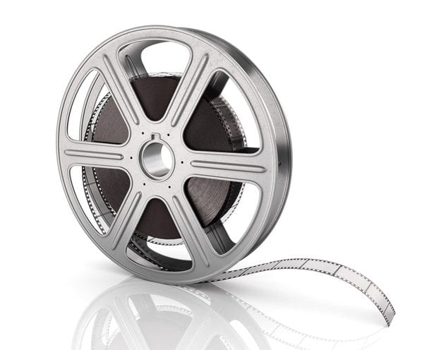 Motion picture film reel on the white background. Motion picture film reel on the white background.