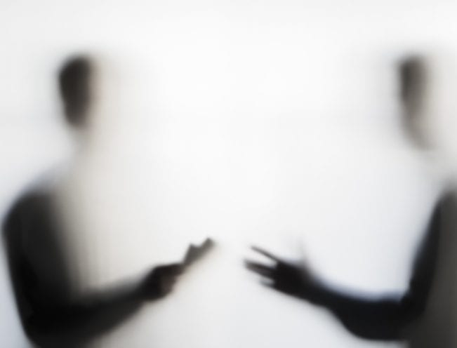 Two men negotiating behind curtain Two men making dubious nogotiation behind a curtain concept