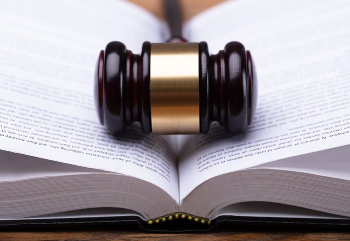 Close-up Of Gavel And Law Book Close-up Of Wooden Gavel And Open Law Book