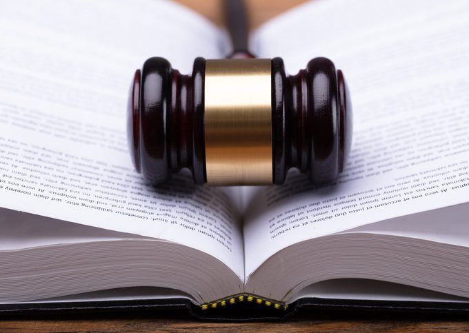 Close-up Of Gavel And Law Book Close-up Of Wooden Gavel And Open Law Book