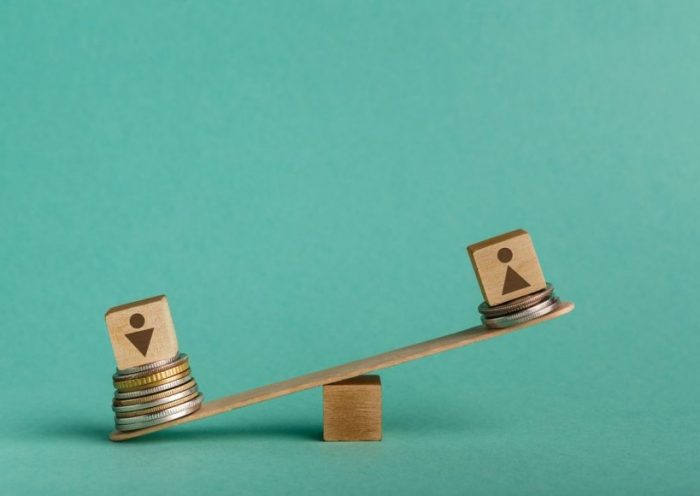 Illustration of gender pay gap with money and seesaw Gender pay gap. Seesaw with wooden cubes with signs of men and women with different stacks of coins, man get bigger salary, copy space