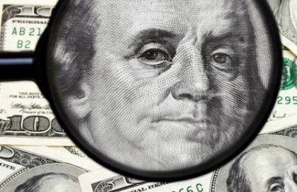 Examining the banknote of one hundred dollar Examining the banknote of one hundred dollar