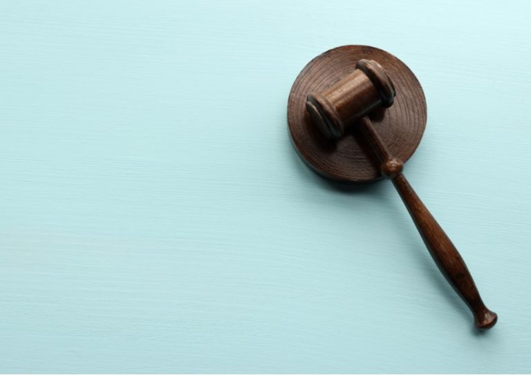 wooden-gavel-on-blue-background-picture-id1285680895