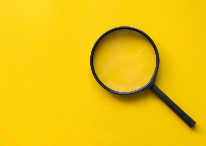 close-up-magnifier-glass-on-yellow-background-for-design-on-web-page-picture-id1133860020