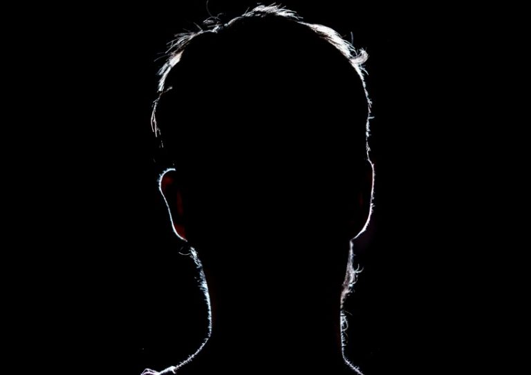 lighten-portrait-silhouette-of-a-human-head-in-the-dark-background-picture-id1028373274