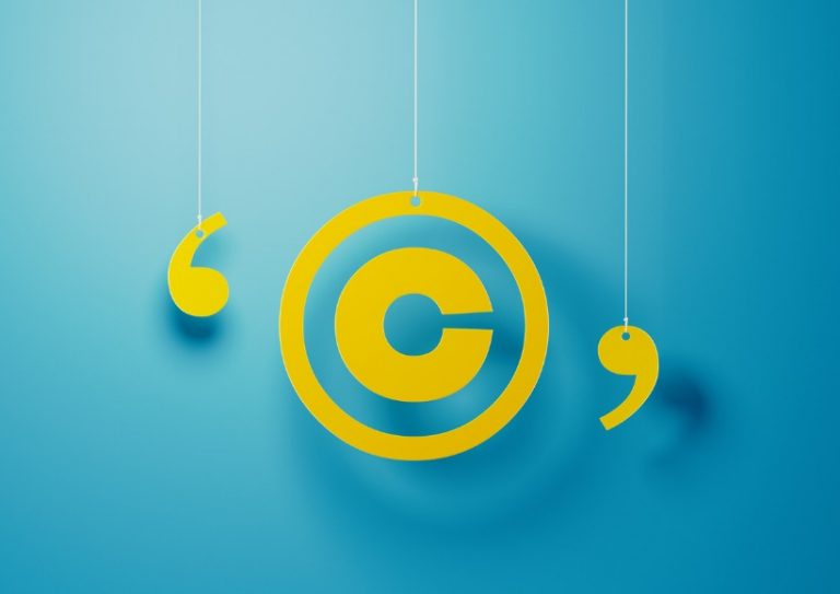 yellow-copyright-symbol-with-string-over-blue-background-picture-id1142821360