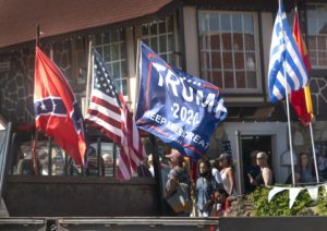 Truck with Confederate, U.S. and Donald Trump flags on it.