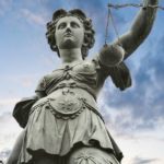 Lady Justice looking formidable with sword and scales.