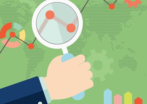 Growth chart with magnifying glass focusing on point. Hand holding a magnifying glass in front of lines on a chart