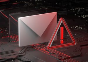 Stylized visualization of electronic circuitry with an envelope and exclamatory alarm sign in front of it.