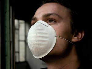 Person wearing a dust mask.