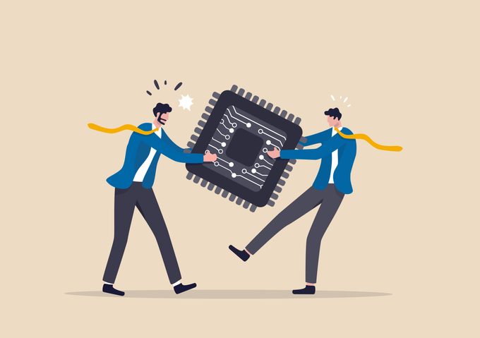 Semiconductor and computer chip supply chain shortage due to Coronavirus COVID-19 pandemic, electronics manufacturing problem concept, businessman tug of war fighting to get computer chip. Two cartoonish figures struggling over possession of an oversized representation of a chip.