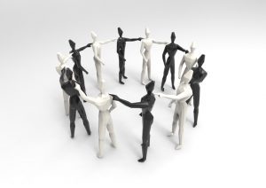 Wooden human figures in a circle, holding hands.
