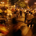 Night scene: demonstrating crowd in the street.