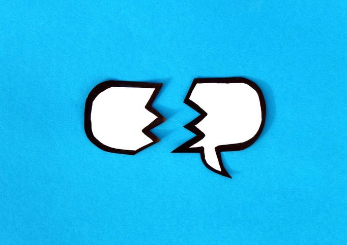 On a blue background lies a torn cloud for thoughts. Illustration of a word balloon broken in half.