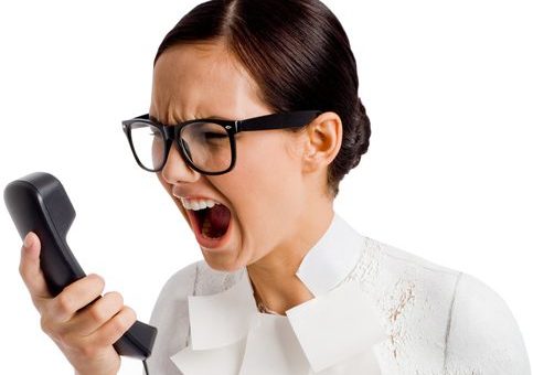 Angry secretary Angry woman yelling into phone.