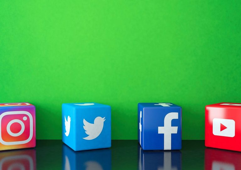Marble Cubic Social media services icons on black glass with green copy space Istanbul, Turkey - October 26, 2019: Marble Cube shape of popular social media services icons, including Facebook, Instagram, Twitter, Youtube on black glass with green copy space