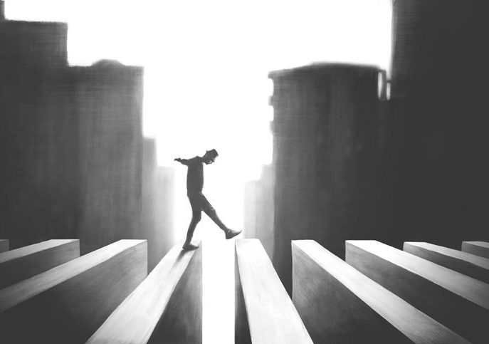 Surreal image in slhouette; man walking across beam-like structure with cityscape in background.