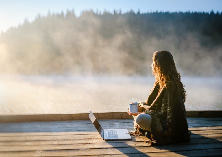 woman-relaxing-in-nature-and-using-technology-picture-id1305227027