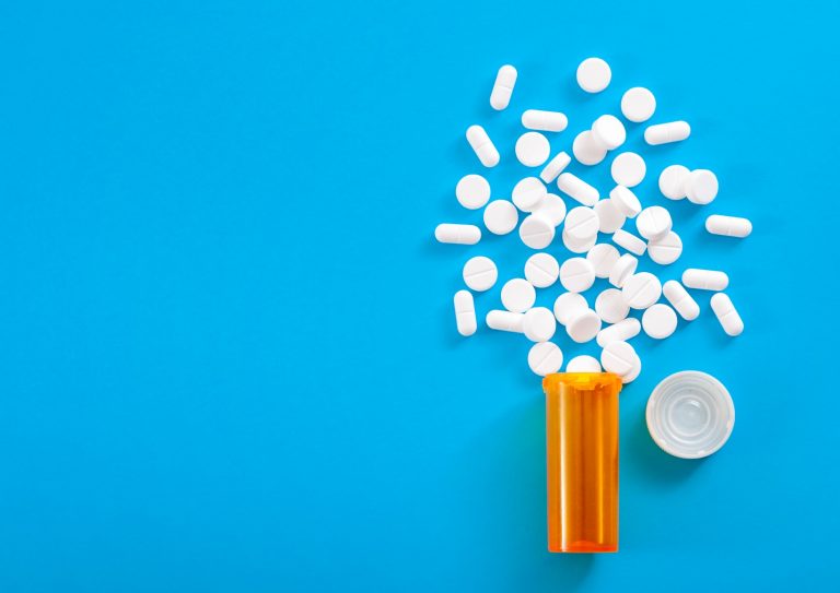 pills-falling-from-pill-bottle-on-blue-background-with-copyspace-picture-id1035982466 pills-falling-from-pill-bottle-on-blue-background-with-copyspace-picture-id1035982466