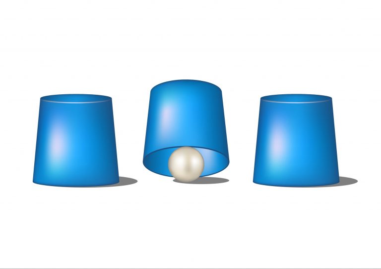 deception pea thumble 35377846 Three thimbles, with a ball barely visible under one of them.