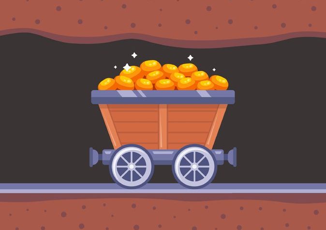Web Old-fashioned mine railroad cart on tracks, with a heaping load of gold nuggets.