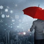 business person holding umbrella symbolizing insurance coverage