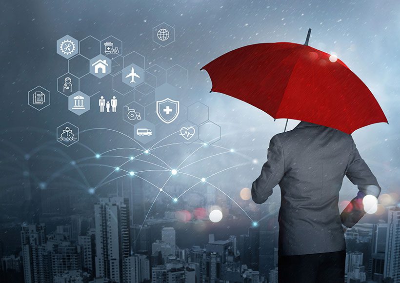 business person holding umbrella symbolizing insurance coverage