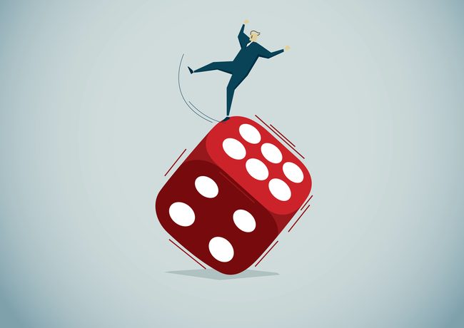 Gamble Illustration of a human figure balancing on the edge of a tipped die.