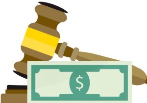 A gavel with a $bill in front of it.
