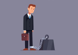business man chained and weighed down by anvil