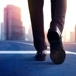 business person walking on road