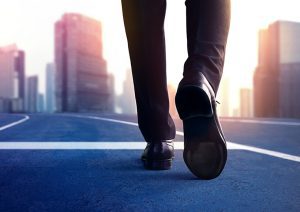 business person walking on road