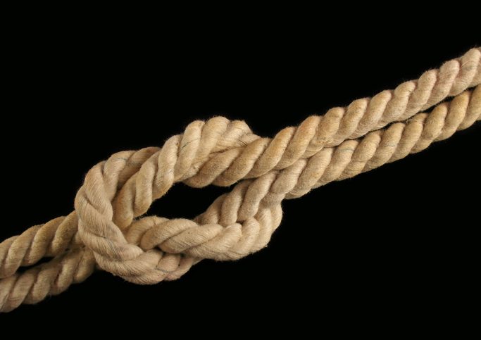 Closeup detail photo of knotted rope.