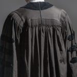 Judge wearing black robe, viewed from the rear.