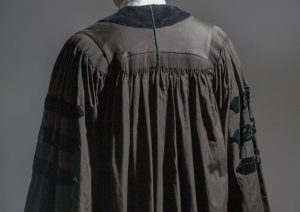 Judge wearing black robe, viewed from the rear.