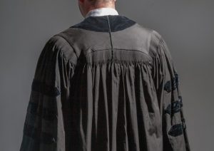A judge wearing black robe, with back to the viewer.