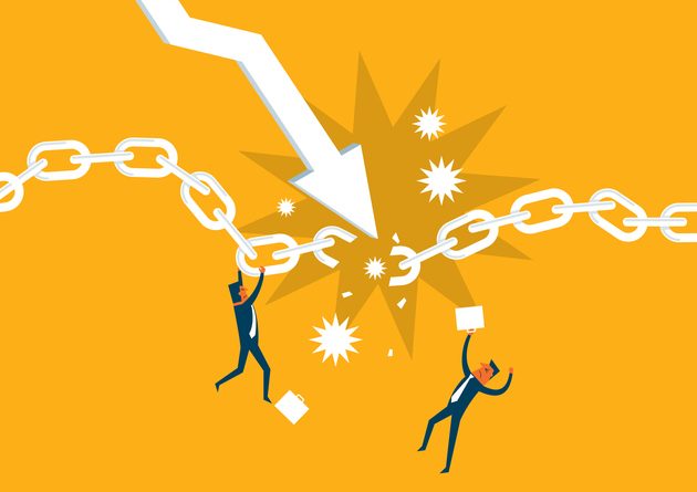 Global demand falls Two cartoonish figures grappling with a big cut chain over their heads, with a big arrow pointing to the broken part.