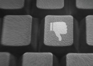 Close up of a few keys on a keyboard. One of them has a "thumbs down" icon on it.