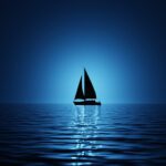 A lone silhouette sailboat on a calm blue sea.