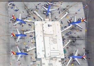 Aerial view of a hangar with several Southwest Airlines planes arranged around it.