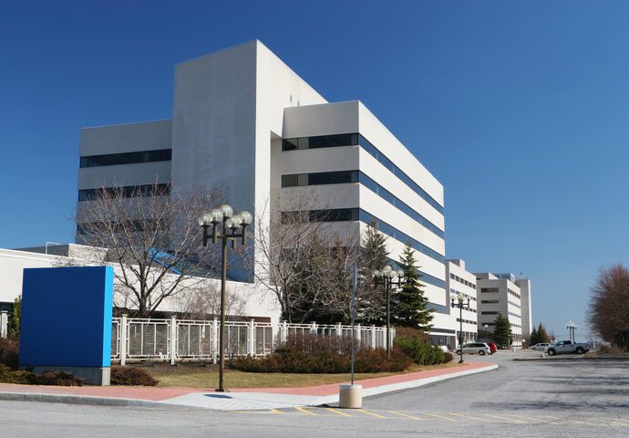 Modern Hospital Building with Sign Color photo of a modern white building that looks like it's probably a hospital.