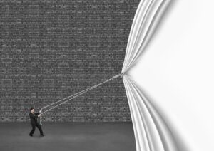 businessman pulling down white curtain covering old dark brick