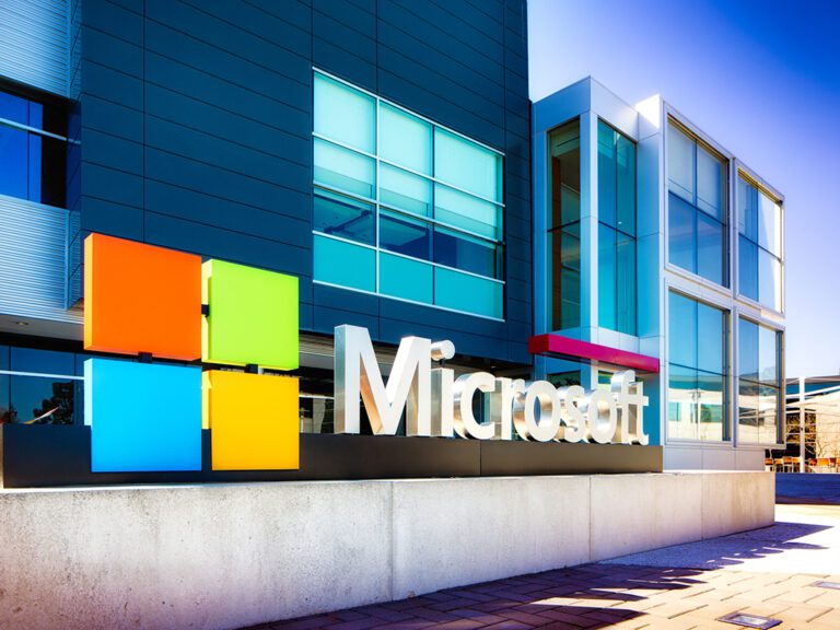 Mountain View, USA - March 4, 2015: Microsoft sign at the entrance of their Silicon Valley campus in Mountain View, California. One of the main buildings can be seen in the background. Oblique view.